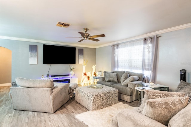 living room with light hardwood / wood-style flooring, ceiling fan, and ornamental molding