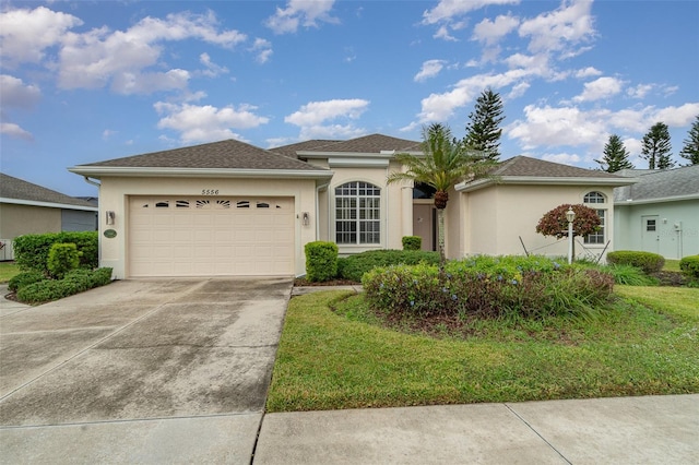 view of front of home with a garage and a front lawn