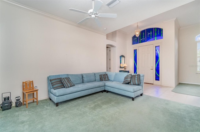 living room with carpet flooring, crown molding, and ceiling fan with notable chandelier