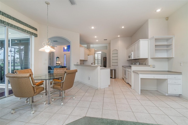 kitchen featuring hanging light fixtures, white cabinets, kitchen peninsula, white appliances, and light tile patterned flooring