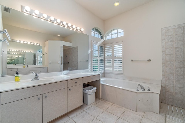 bathroom with tile patterned floors, vanity, a healthy amount of sunlight, and separate shower and tub