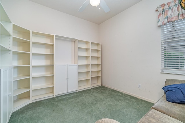 interior space with dark colored carpet and ceiling fan