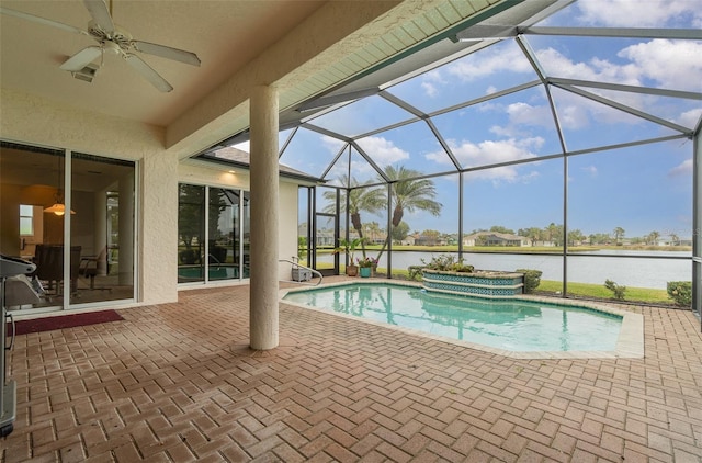 view of swimming pool with a water view, a patio area, ceiling fan, and a lanai