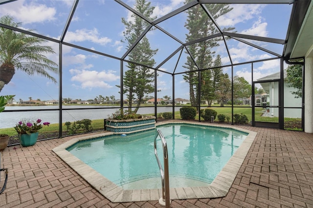 view of pool featuring glass enclosure, a patio area, and a water view