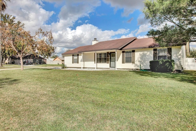 rear view of house featuring a yard