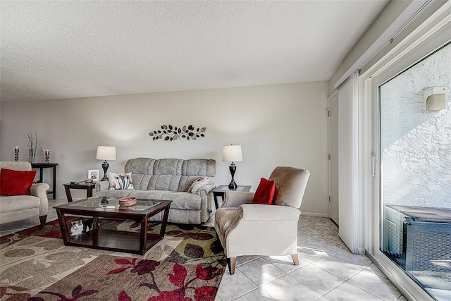 tiled living room featuring a textured ceiling