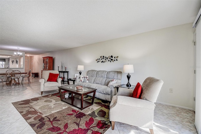 tiled living room featuring a notable chandelier and a textured ceiling