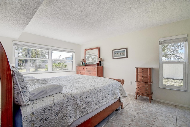 bedroom with light tile patterned flooring and a textured ceiling