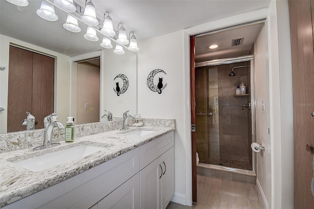 bathroom with vanity and a shower with shower door