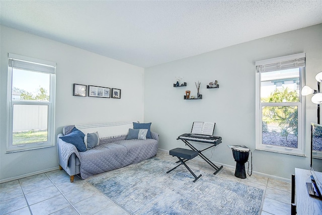 sitting room featuring light tile patterned floors and a textured ceiling