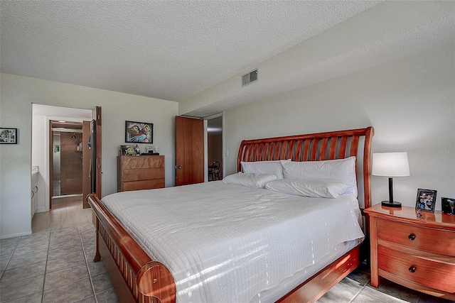 bedroom with light tile patterned floors and a textured ceiling