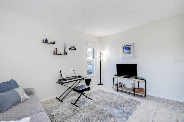 living room with light tile patterned floors and a textured ceiling