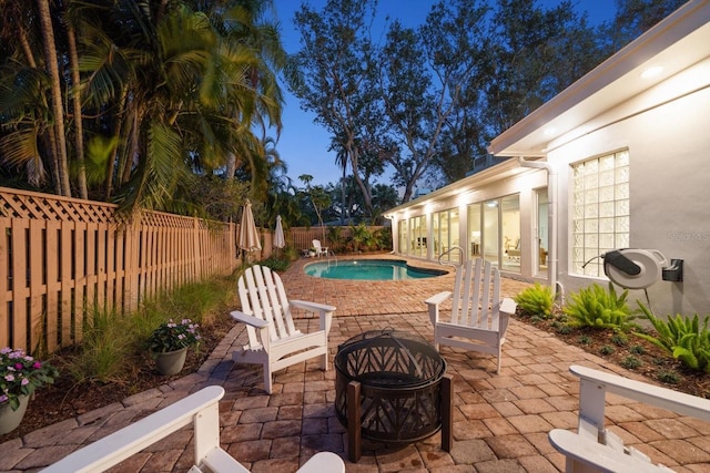 view of pool featuring a patio and an outdoor fire pit