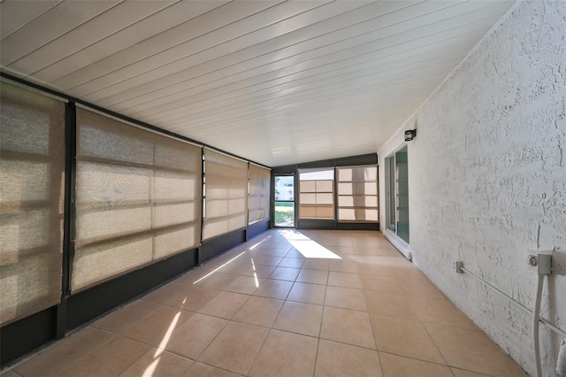 unfurnished sunroom featuring lofted ceiling