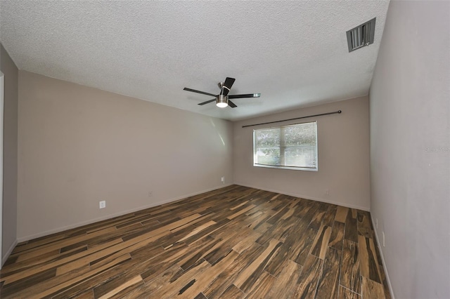 empty room featuring ceiling fan, dark hardwood / wood-style flooring, and a textured ceiling