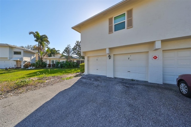 view of home's exterior featuring a garage and a yard