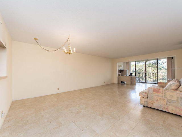 unfurnished living room with a chandelier