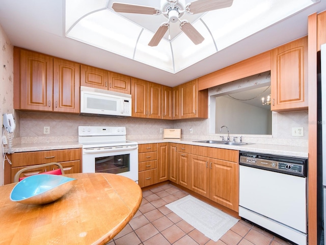 kitchen featuring ceiling fan, sink, tasteful backsplash, white appliances, and light tile patterned flooring