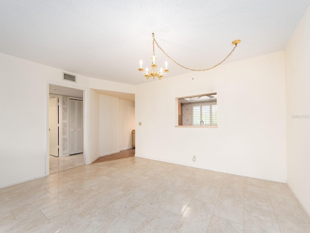 empty room with an inviting chandelier