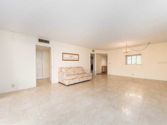 unfurnished living room featuring a notable chandelier