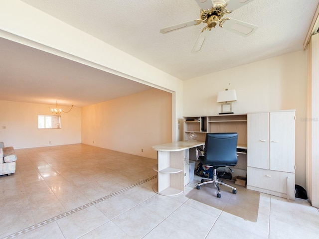 unfurnished office featuring light tile patterned floors, ceiling fan with notable chandelier, and a textured ceiling