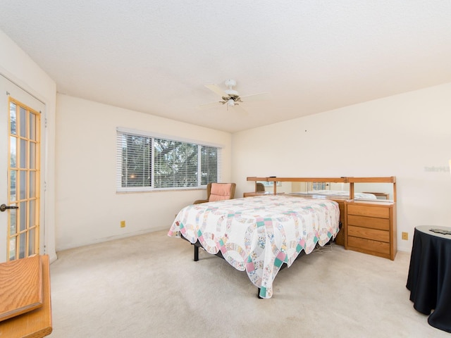 bedroom with light colored carpet and ceiling fan