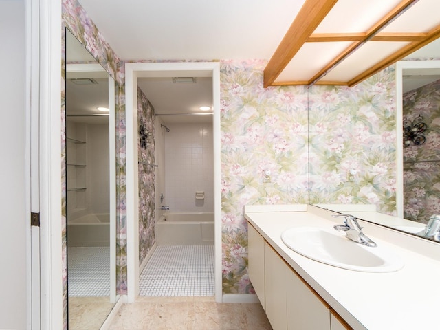 bathroom with vanity and tiled shower / bath combo