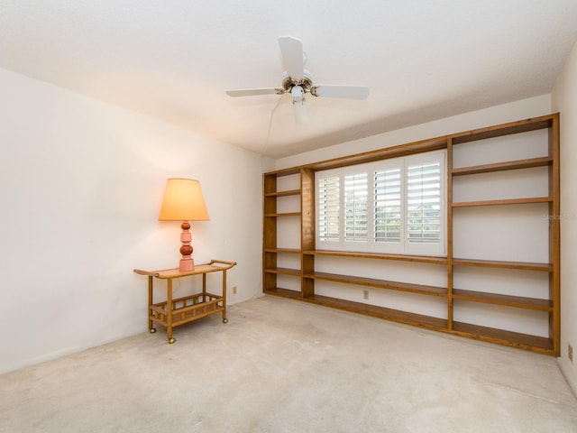 interior space featuring light carpet and ceiling fan