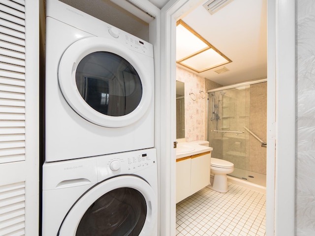 laundry room with stacked washer / dryer, sink, and light tile patterned floors