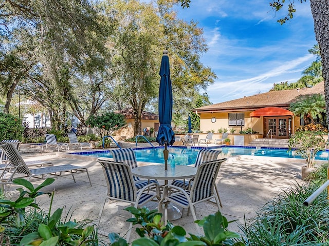 view of pool featuring a patio and french doors