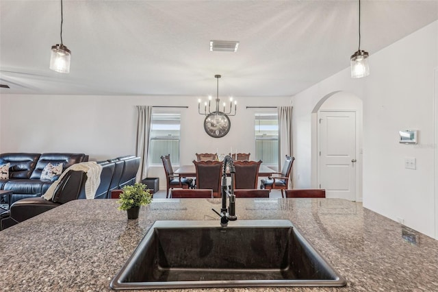 kitchen with hanging light fixtures, a notable chandelier, and sink