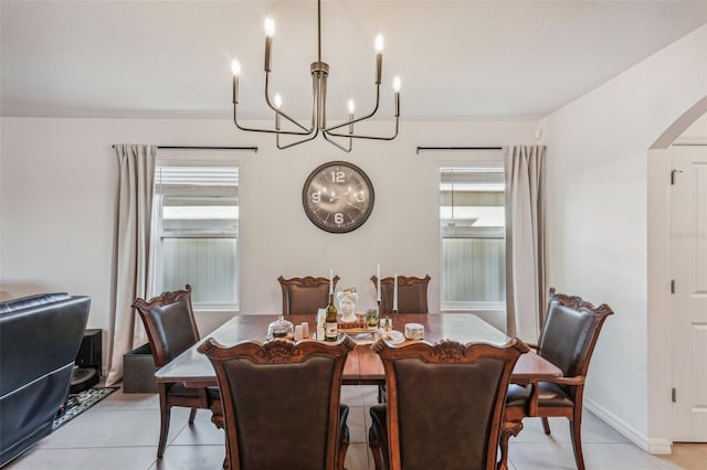 tiled dining space with an inviting chandelier