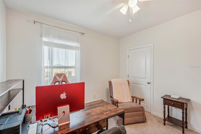 carpeted office space featuring ceiling fan