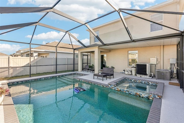 view of swimming pool featuring glass enclosure, an in ground hot tub, a patio area, and cooling unit