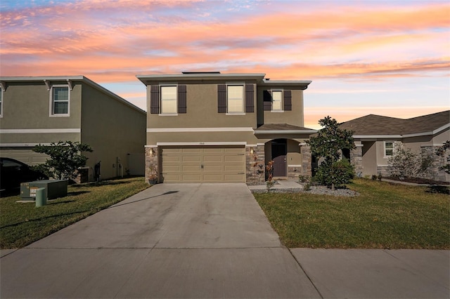 view of front of property with a yard and a garage