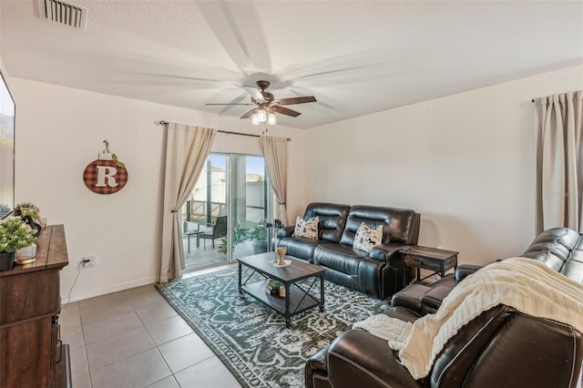 living room with ceiling fan and light tile patterned flooring