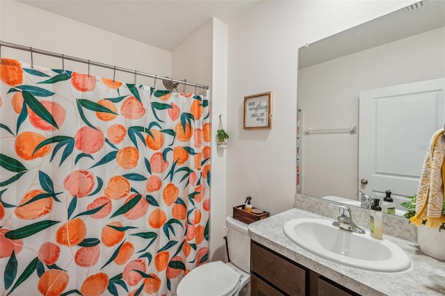 bathroom featuring vanity, a shower with shower curtain, and toilet