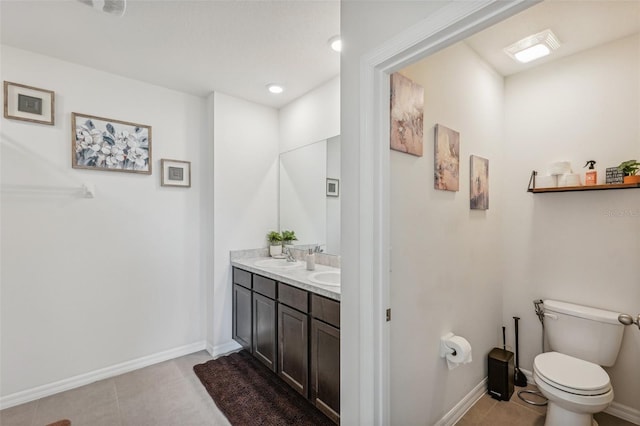 bathroom featuring tile patterned flooring, vanity, and toilet