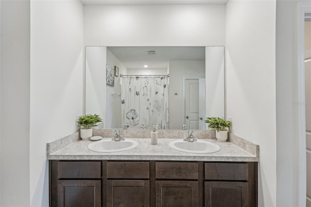 bathroom with vanity and curtained shower