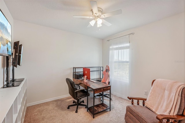 carpeted office space with ceiling fan