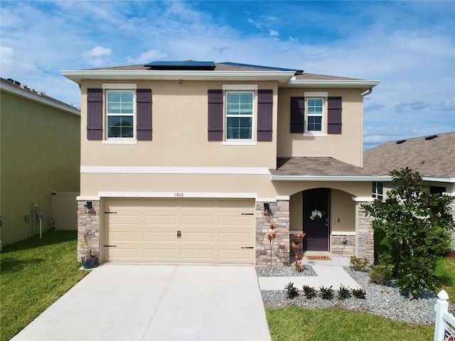 view of front of home with stone siding, solar panels, and stucco siding