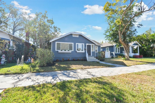 bungalow-style home with a front yard