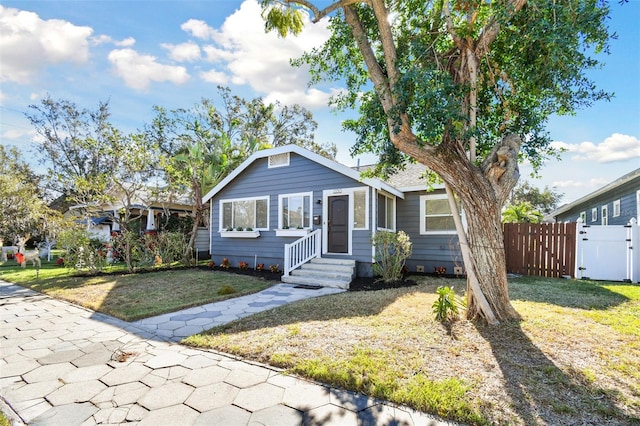 bungalow-style home with a front lawn