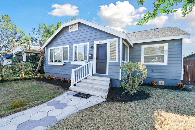 bungalow with a front yard