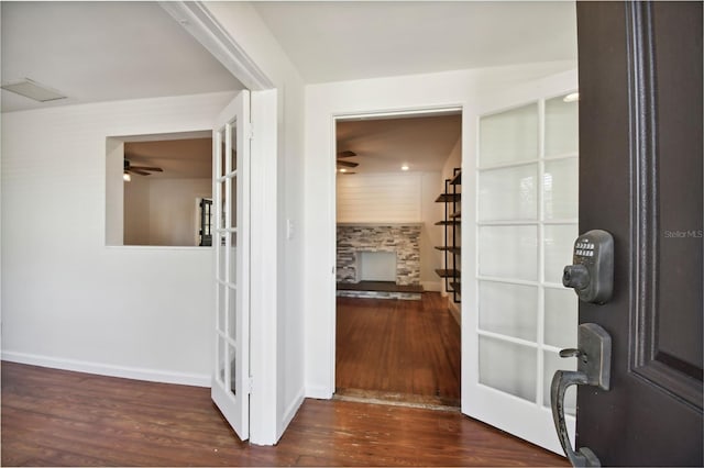 hallway with french doors and dark wood-type flooring