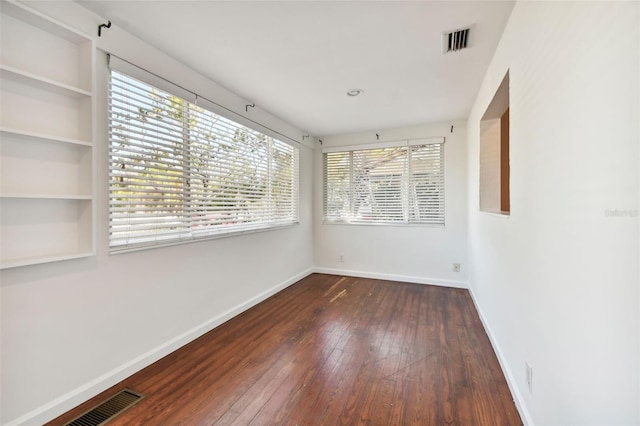 spare room featuring dark hardwood / wood-style flooring