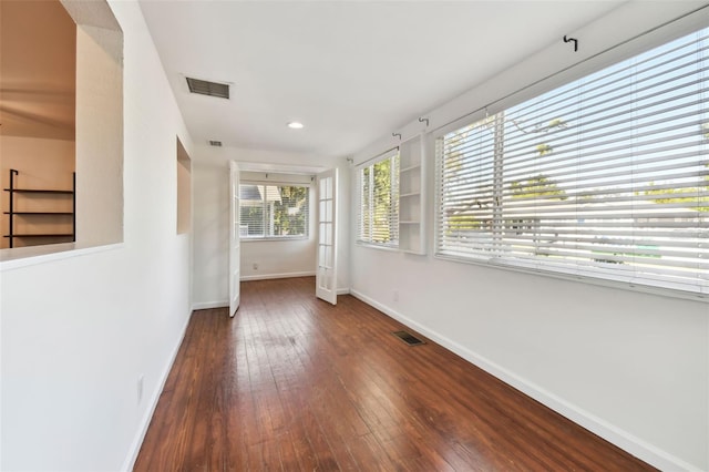 spare room featuring dark wood-type flooring