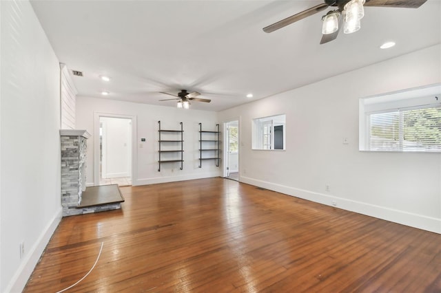 unfurnished living room with hardwood / wood-style flooring and ceiling fan