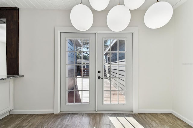 doorway with wood-type flooring and french doors