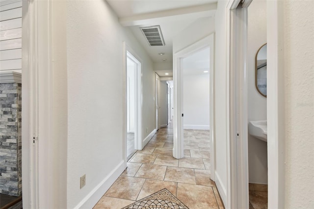 corridor with light tile patterned flooring